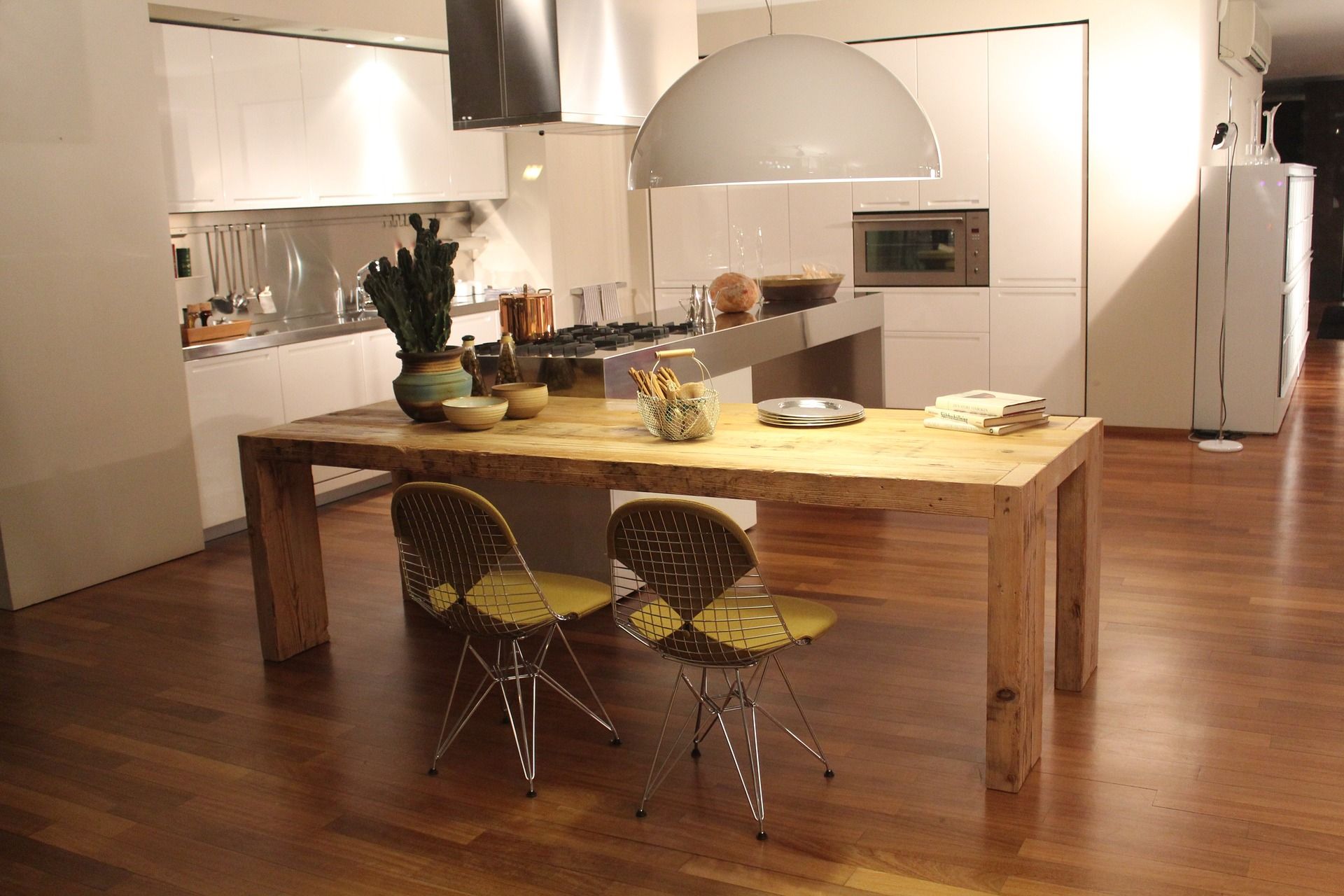 A kitchen with a wooden table and yellow chairs