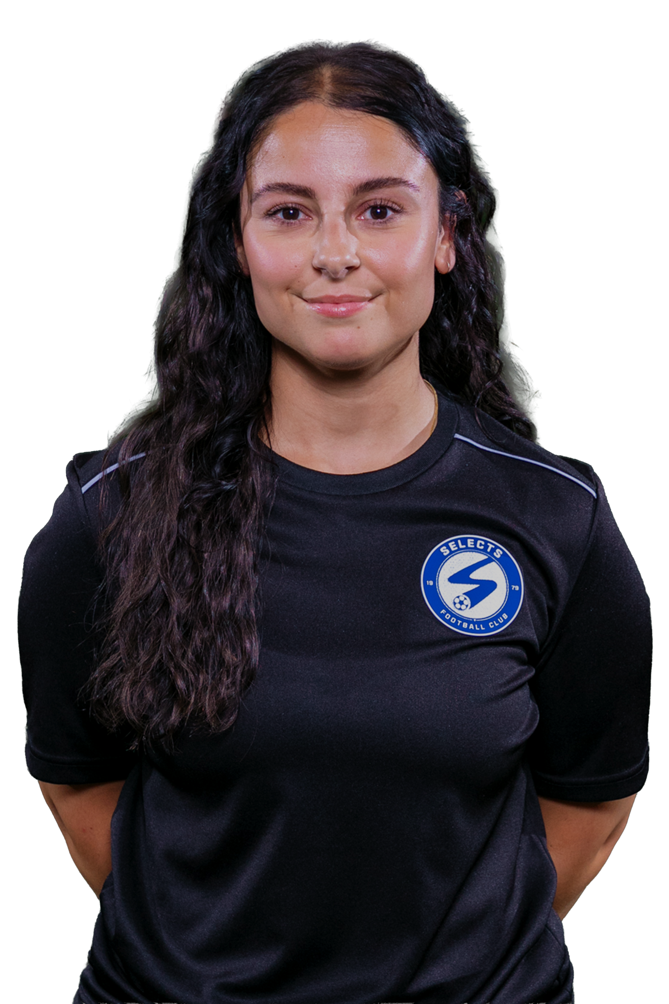 A smiling person with dark curly hair and glasses, wearing a blue zip-up athletic jacket with a white logo.