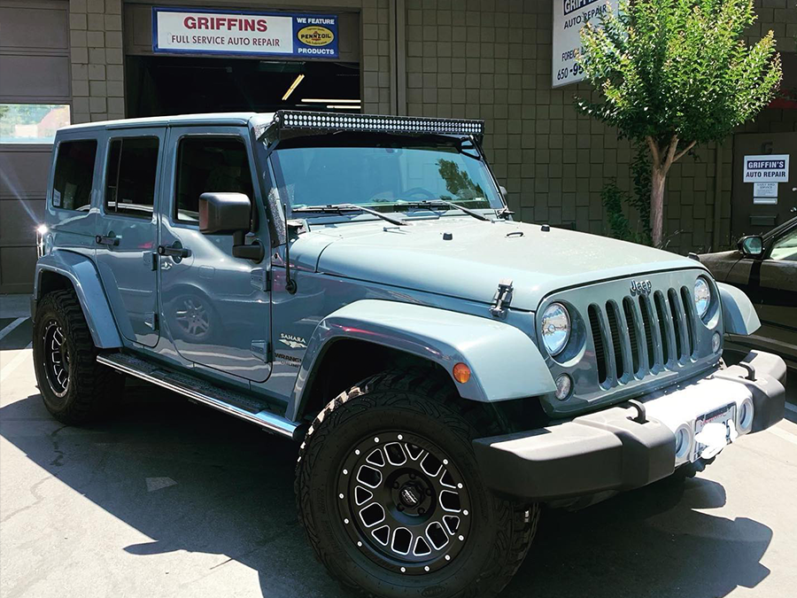 Light blue Jeep Wrangler parked outside a Griffins building