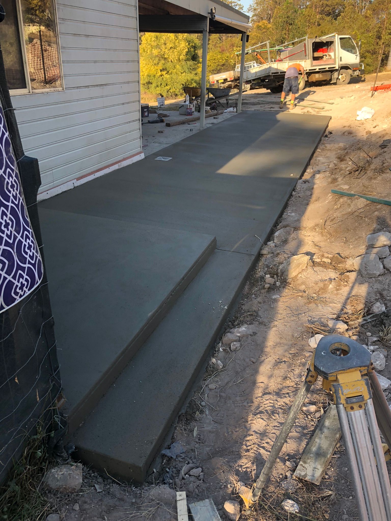 A Concrete Walkway is Being Built in Front of a House — Grafton Concreting & Bobcat Services In South Grafton, NSW