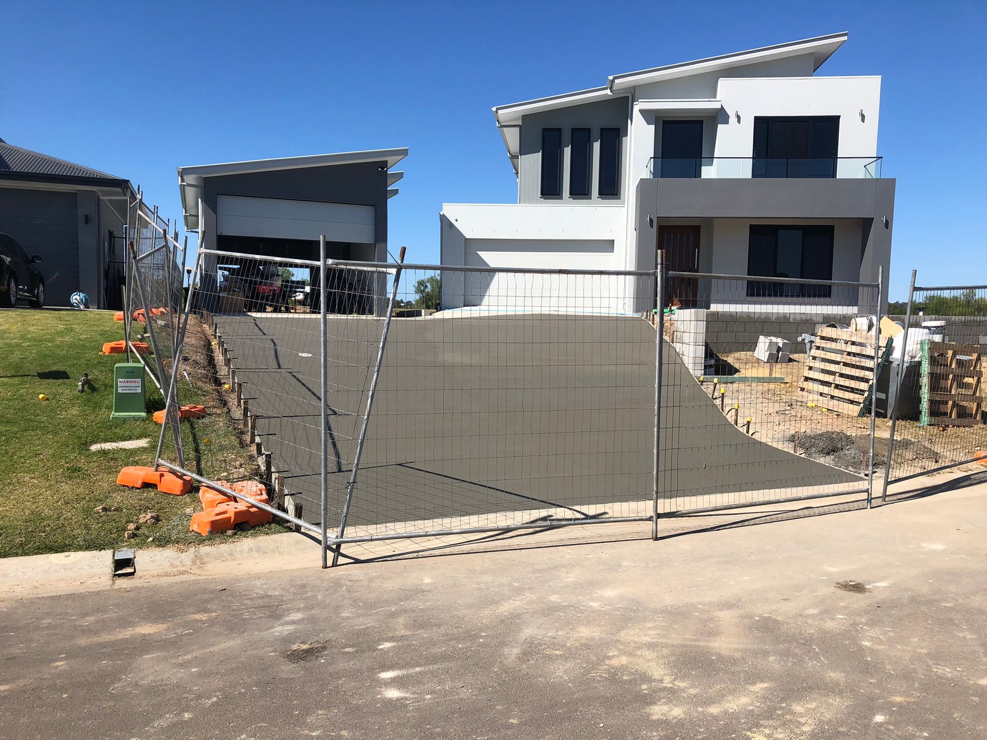 A House is Being Built With a Fence Around It — Grafton Concreting & Bobcat Services In South Grafton, NSW