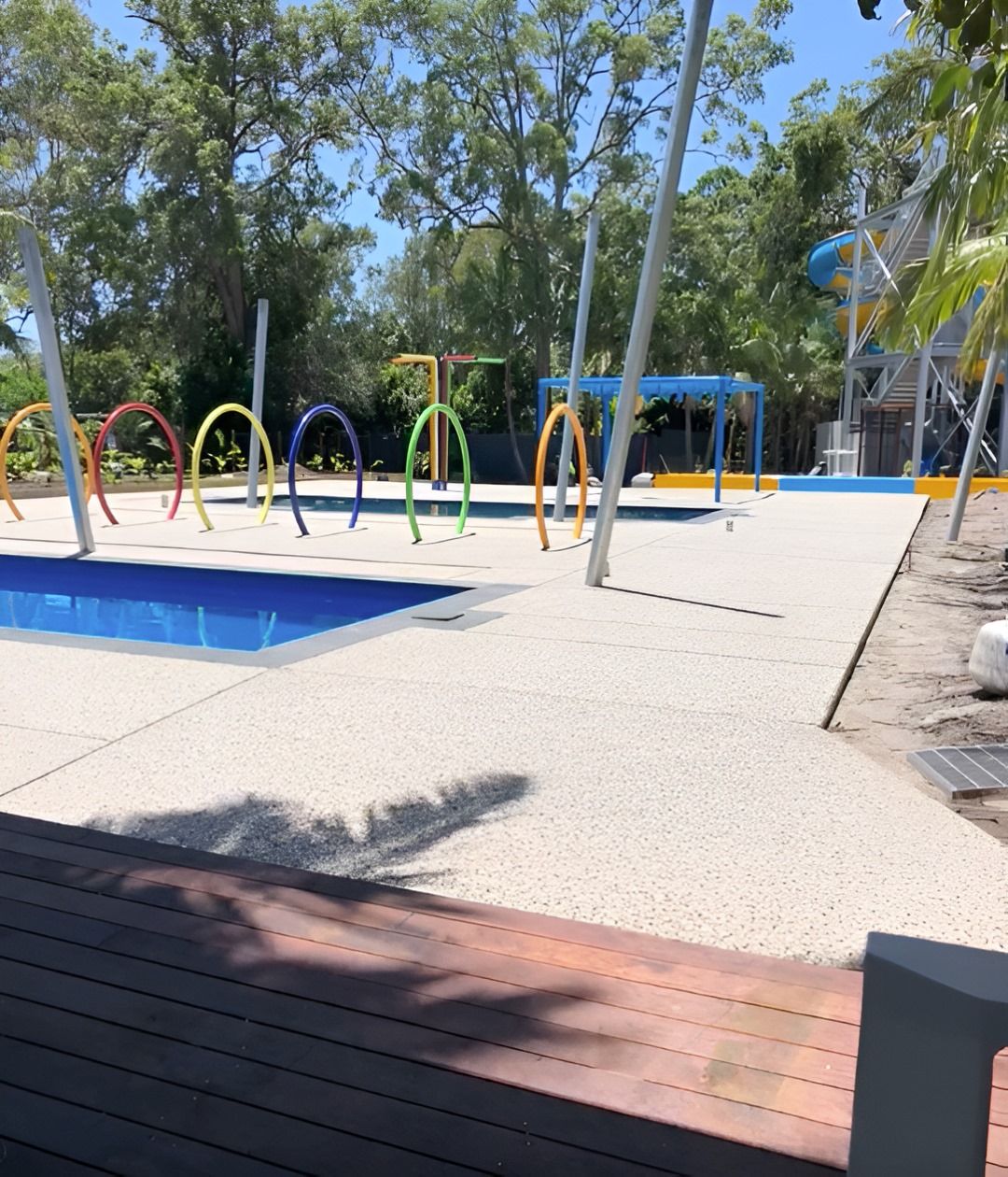 Splash Park With Colourful Hoops, a Small Pool, and a Concrete Ground — Grafton Concreting & Bobcat Services In South Grafton, NSW