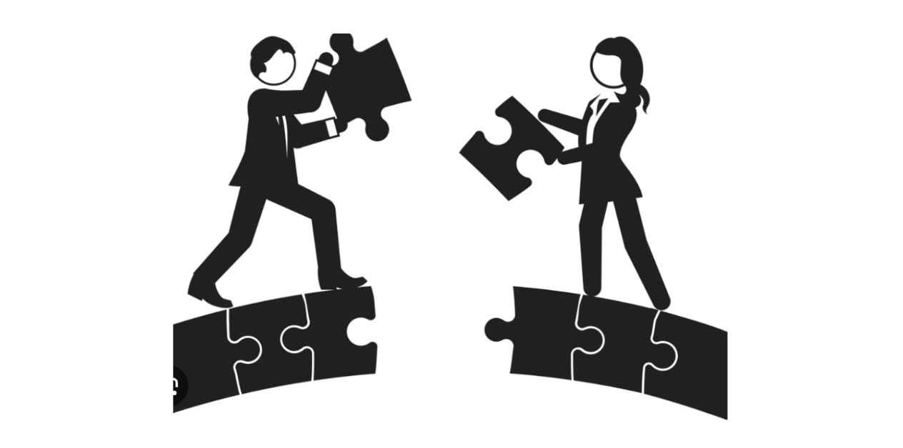 Two silhouetted figures fitting puzzle pieces together on a broken bridge, symbolizing teamwork.