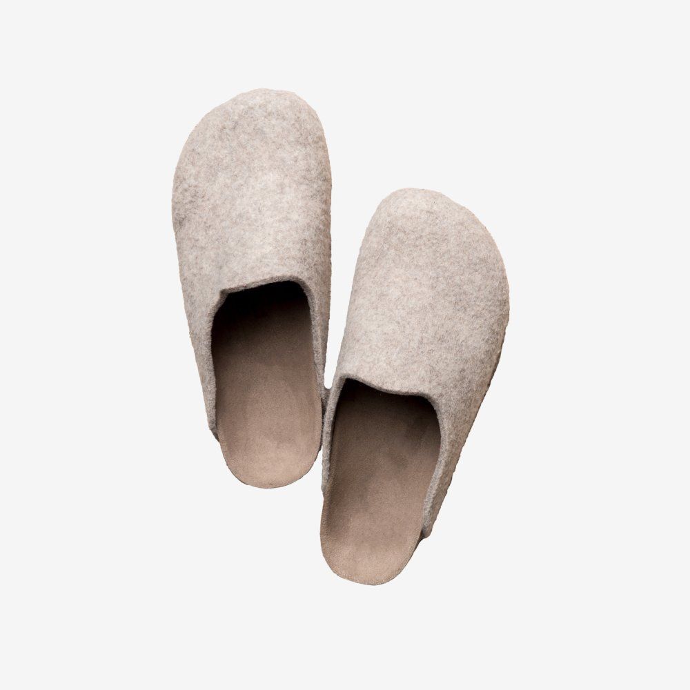 A pair of white slippers on a white background