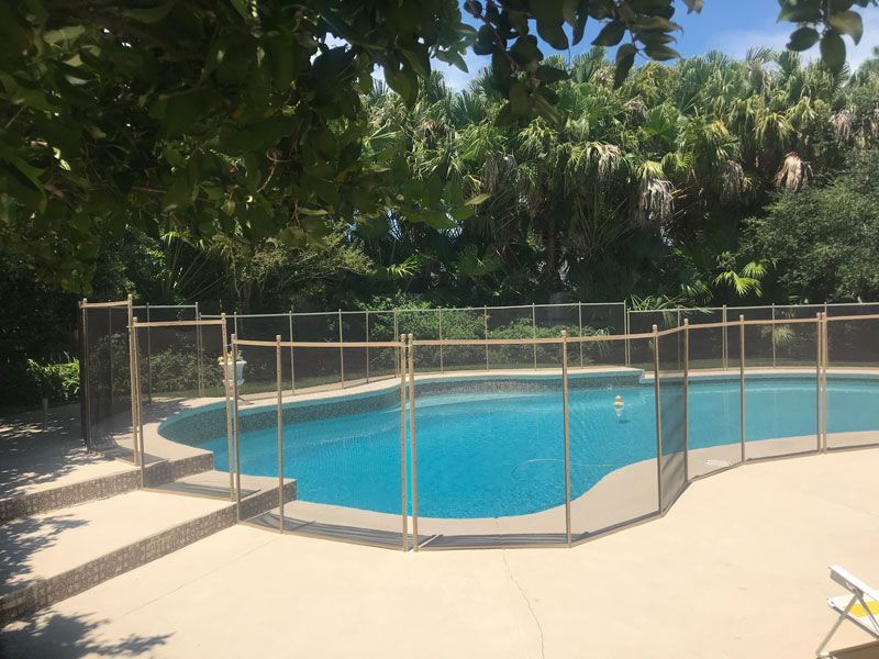 A large swimming pool with a fence around it.