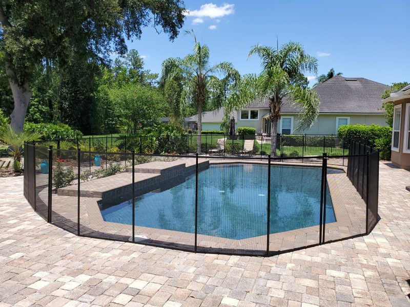 A large swimming pool with a fence around it