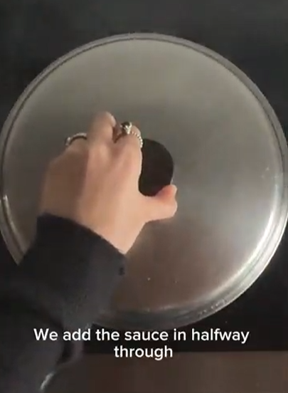 A hand lifts the metal lid of a cooking pot. Text overlay reads: 