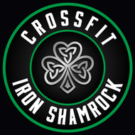 Crossfit Iron Shamrock logo with green ring and shamrock emblem on black background