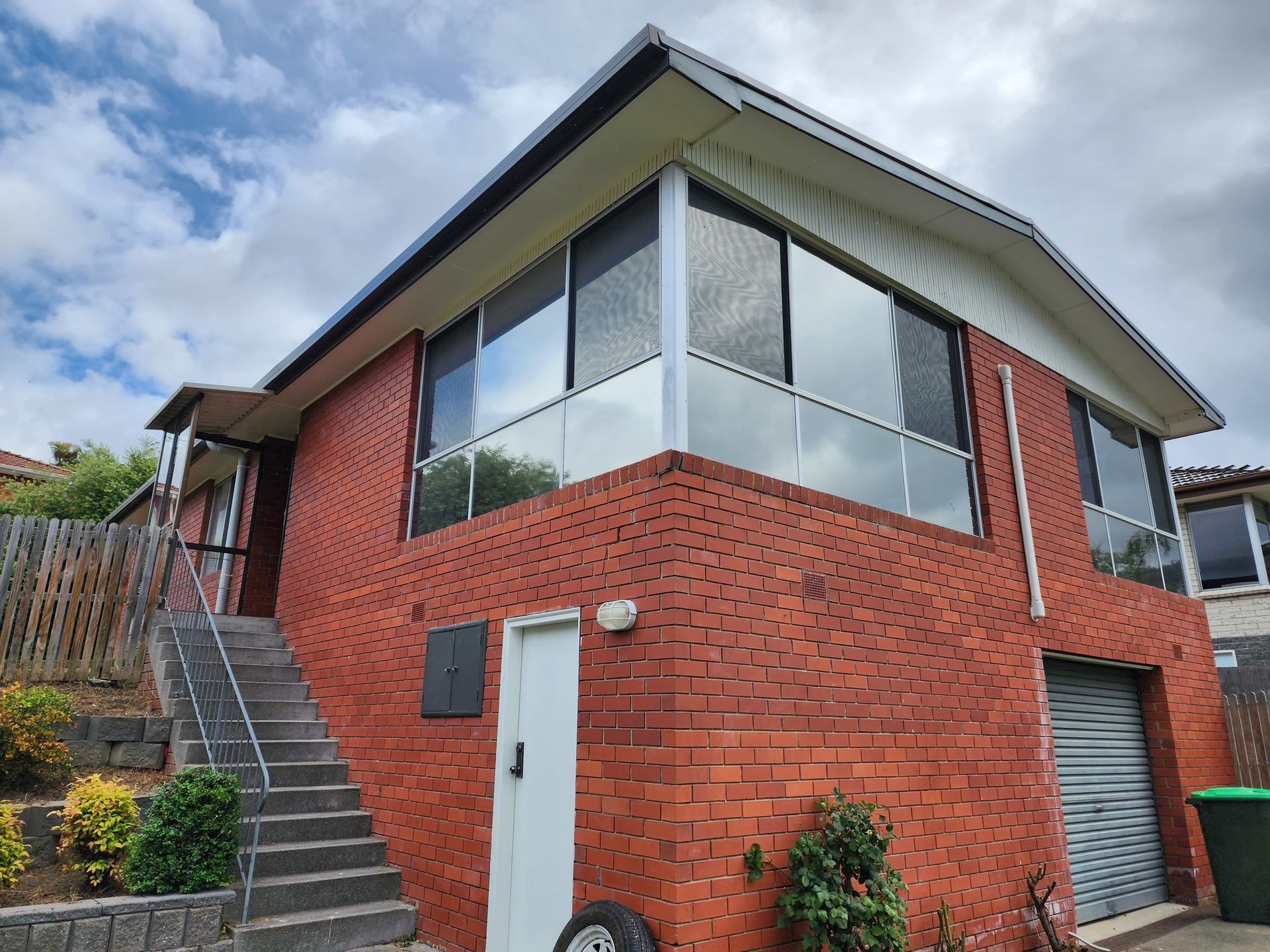A Multi-story Brick House With a Front Staircase — Shmick Tinting & Vinyl in North Hobart, TAS
