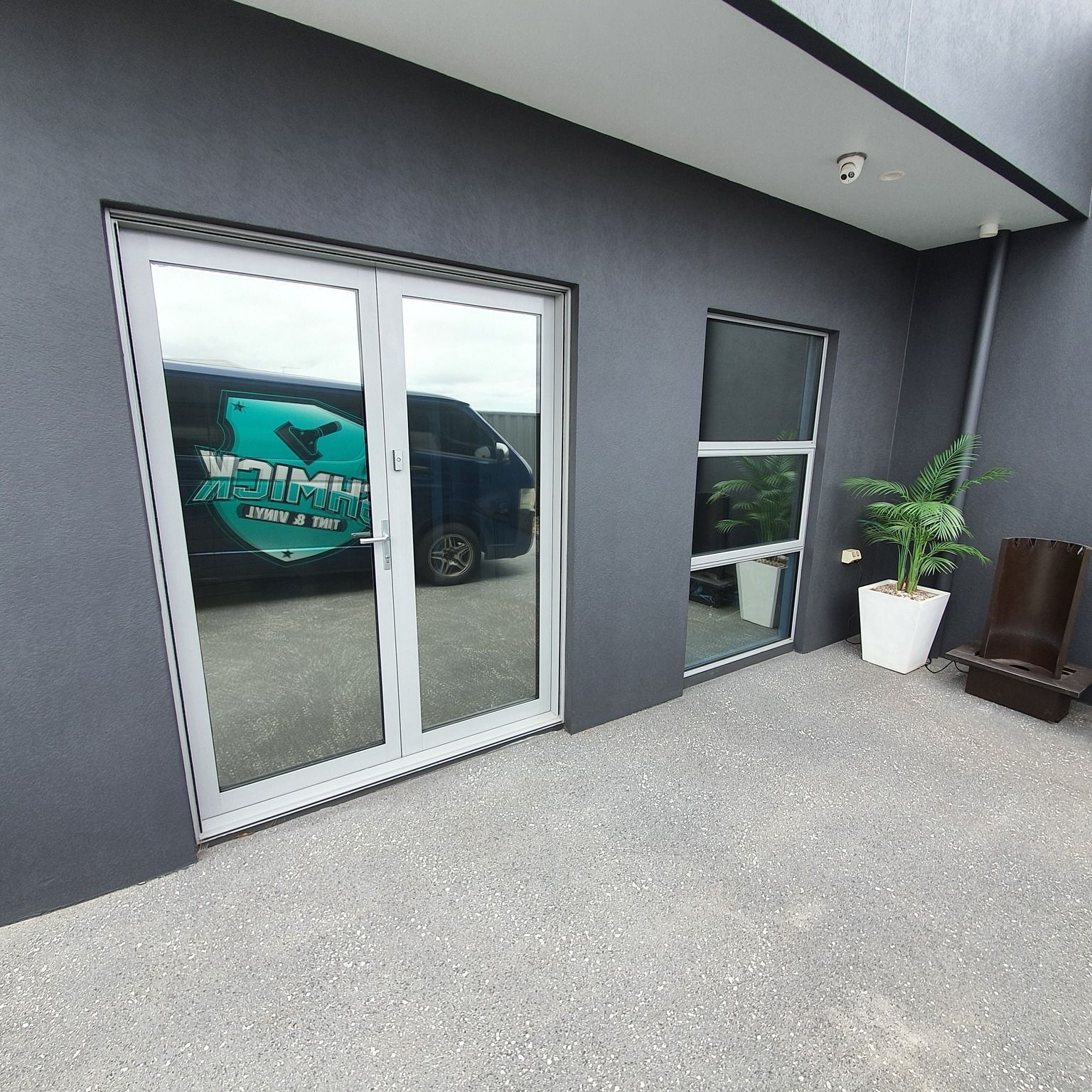 Double White-framed Glass Doors and a Single Window on a Dark Gray Wall — Shmick Tinting & Vinyl in North Hobart, TAS