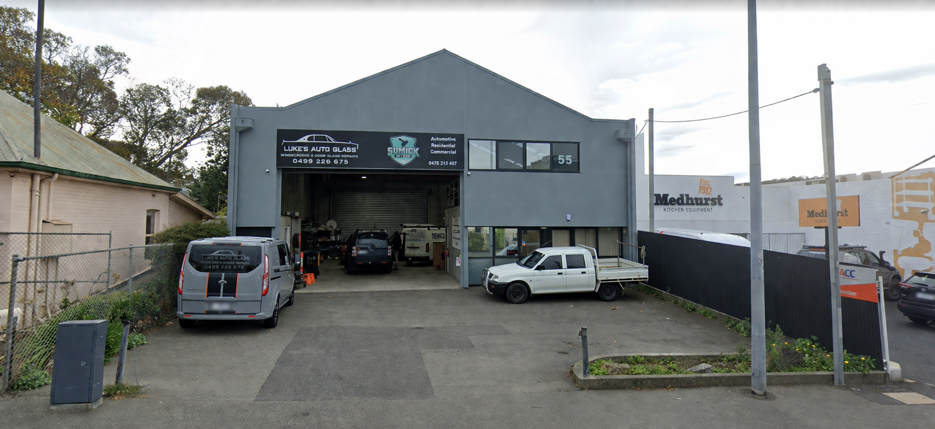 A Modern, Two-story House With Dark Gray Brick Siding — Shmick Tinting & Vinyl in North Hobart, TAS