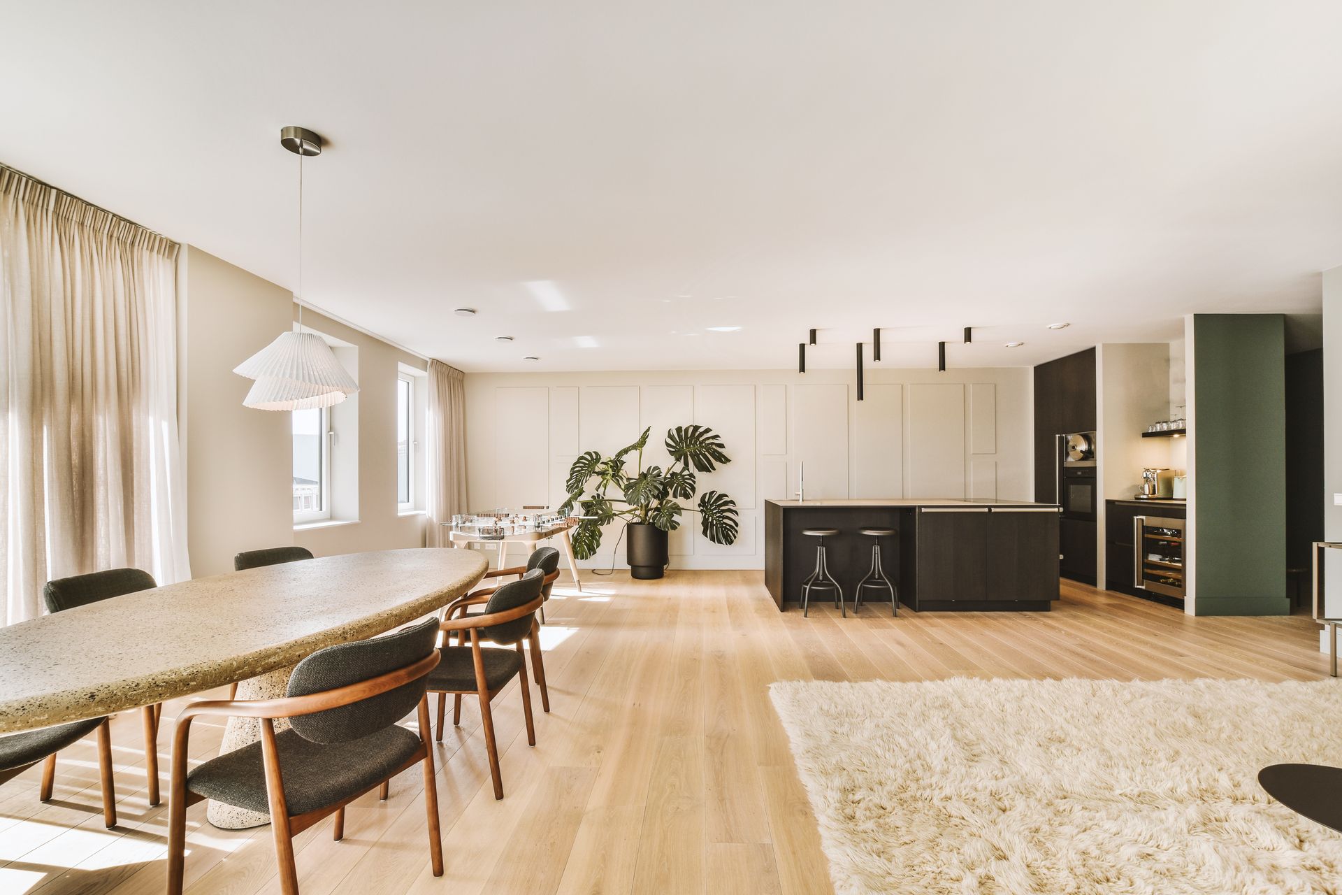 There is a table and chairs in the middle of the room.