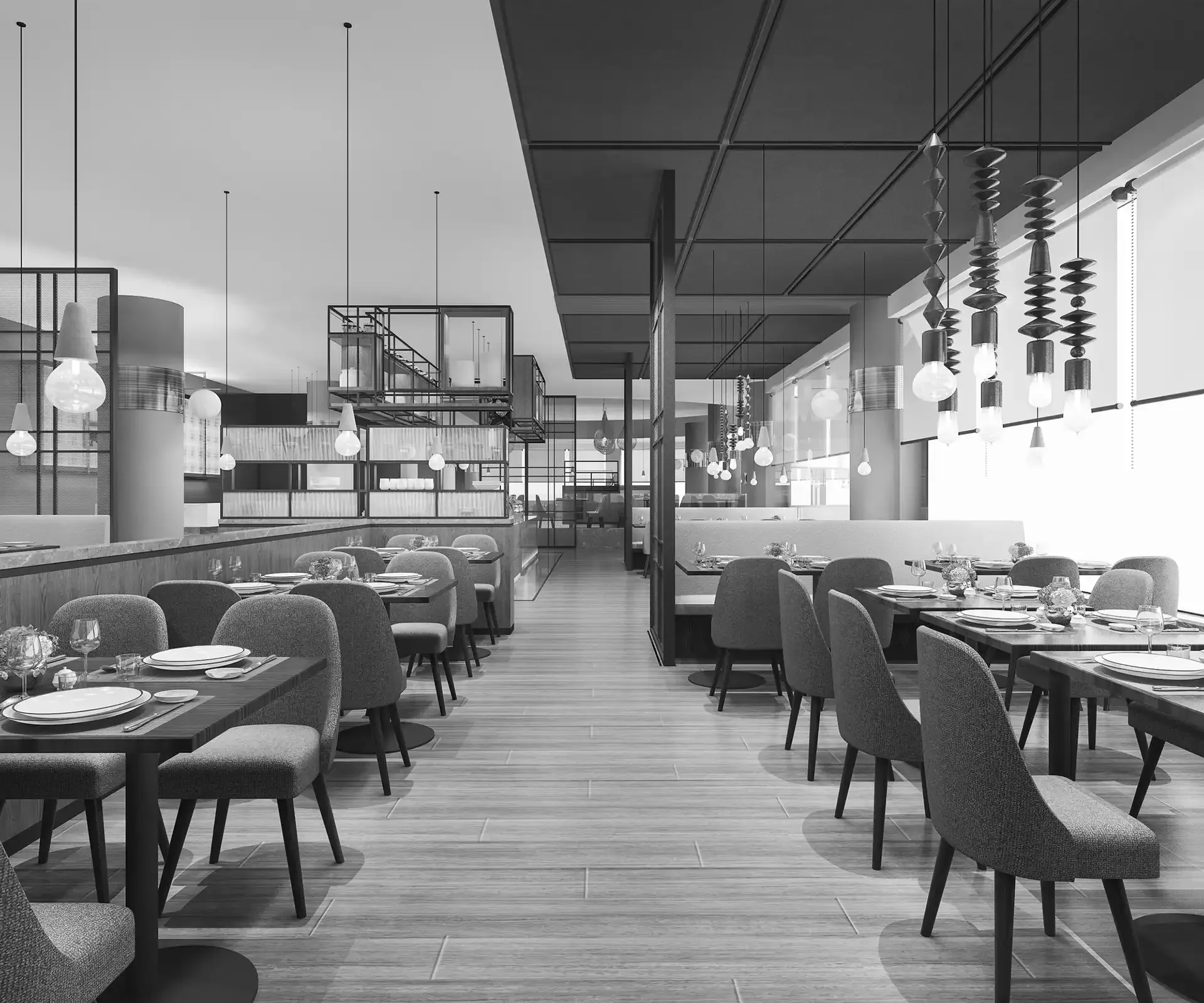 Restaurant interior with tables, chairs, and hanging lights. Black and white photograph.