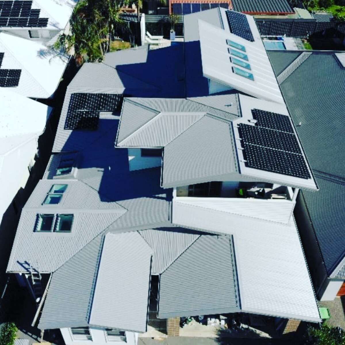 An Aerial View Of A House With Solar Panels On The Roof — Elevated Roofing Systems Pty Ltd In Barrack Heights, NSW