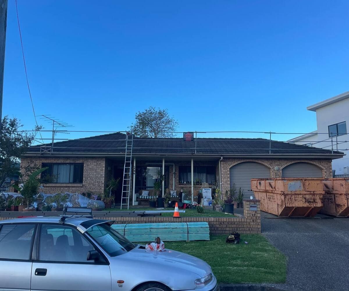 A Silver Car Is Parked In Front Of A Brick House — Elevated Roofing Systems Pty Ltd In Barrack Heights, NSW