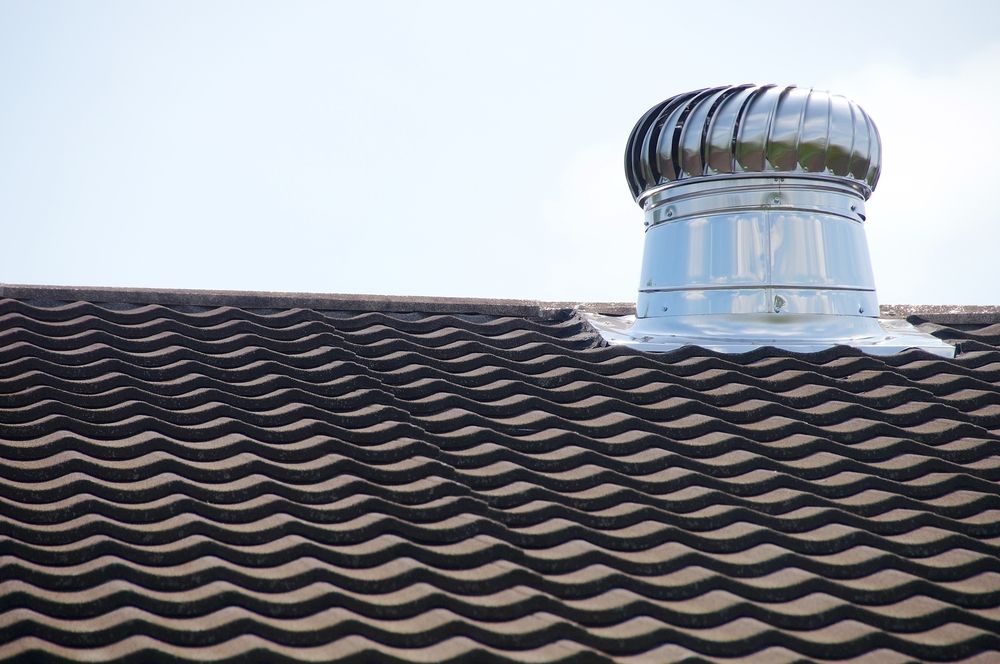 A Roof With A Chimney On Top Of It — Elevated Roofing Systems Pty Ltd In Shellharbour, NSW