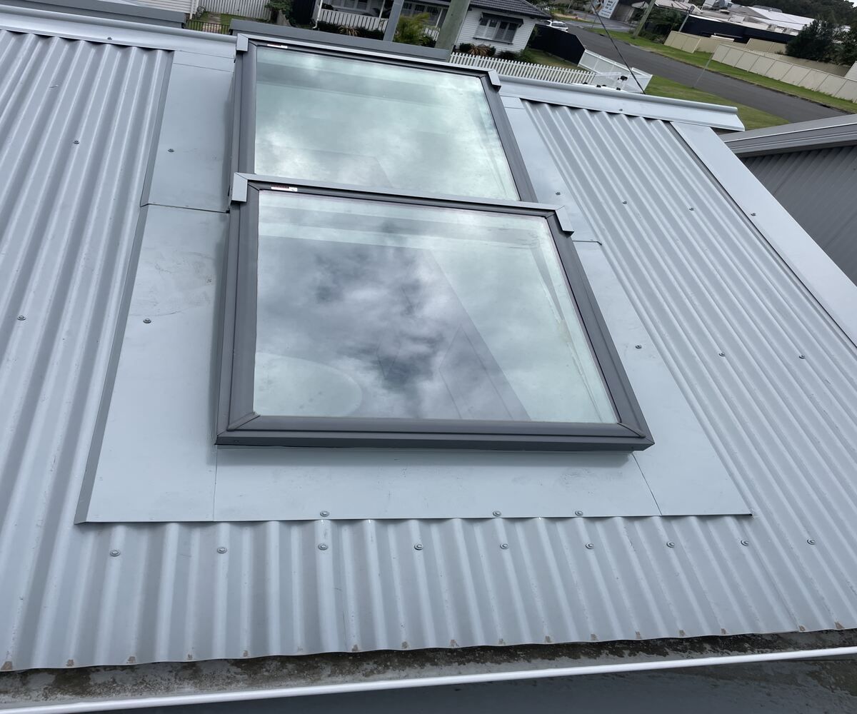 There Are Two Skylights On The Roof Of A Building — Elevated Roofing Systems Pty Ltd In Barrack Heights, NSW