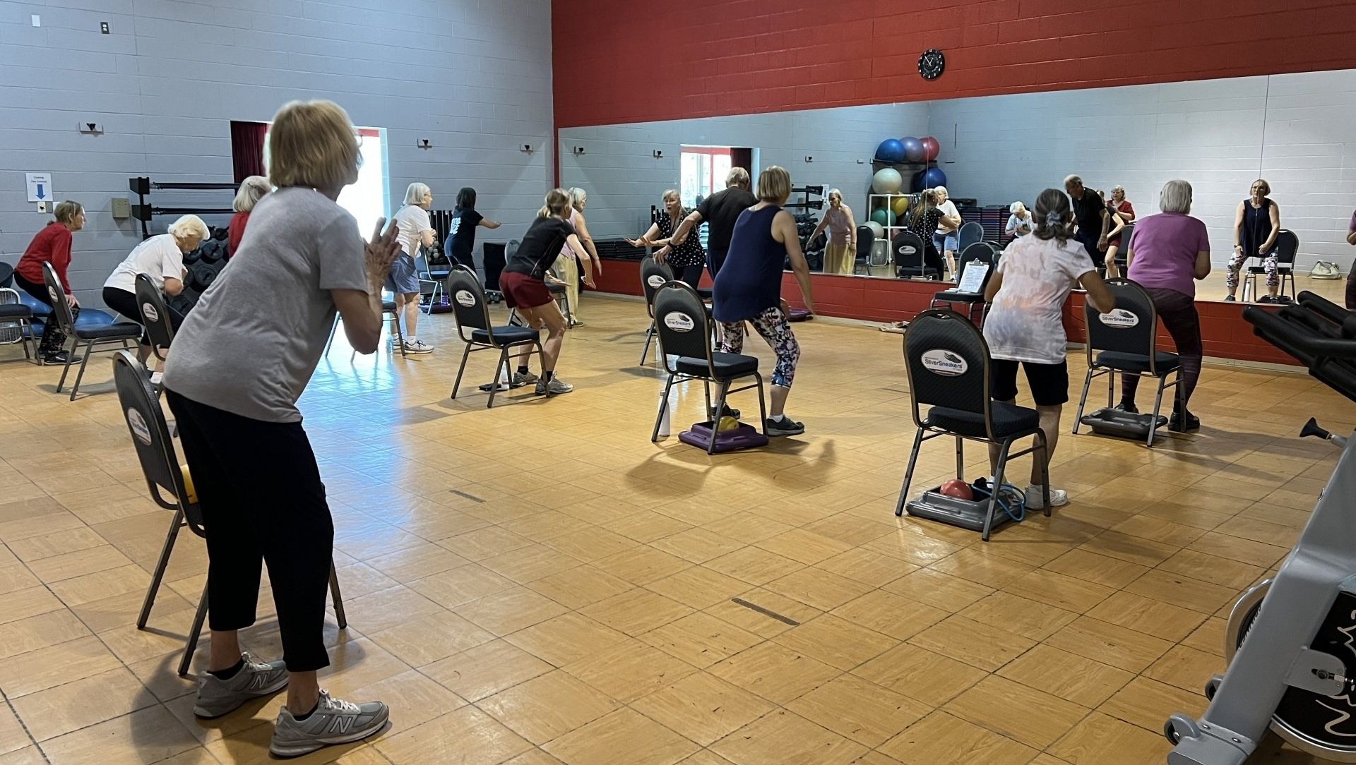 Silver Sneakers workout class doing exercises with chairs at High Altitude  Gym in Taos.