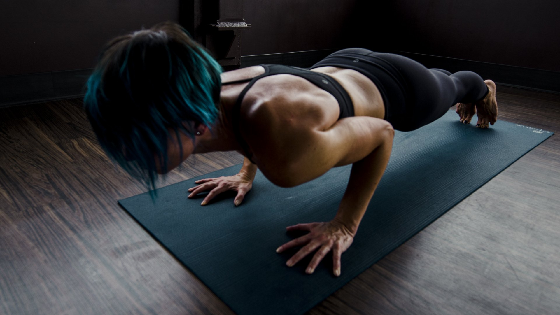 Step exercise equipment along with a mat and weights on the floor.