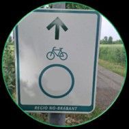 Bord met een fiets- en pijlsymbool, dat de richting van het fietspad aangeeft.