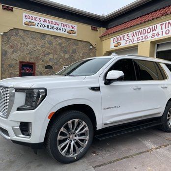 White GMC Yukon parked outside Eddie’s Window Tinting shop