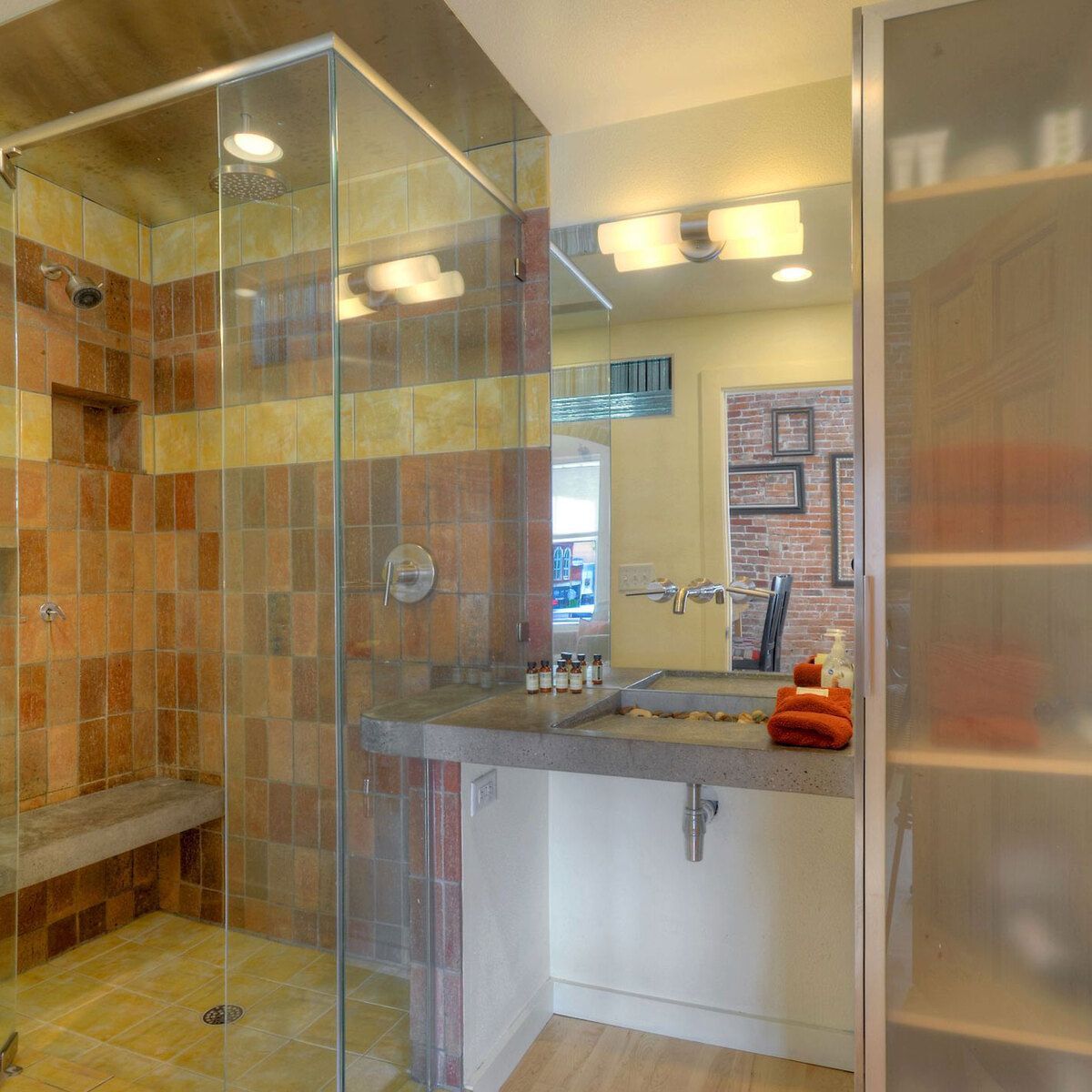 A bathroom with a shower, sink, and mirror
