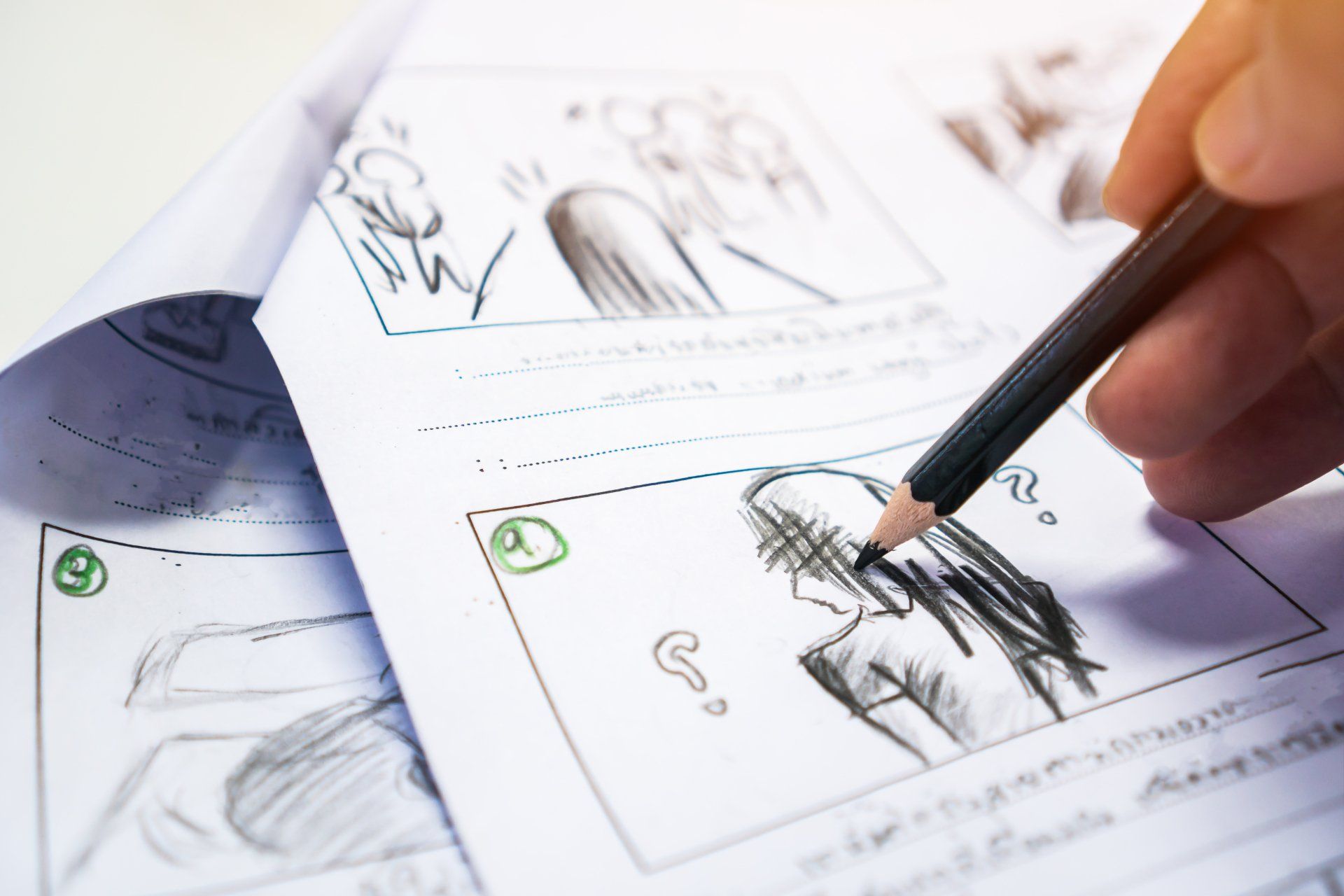 A person is drawing a picture with a pencil on a piece of paper.