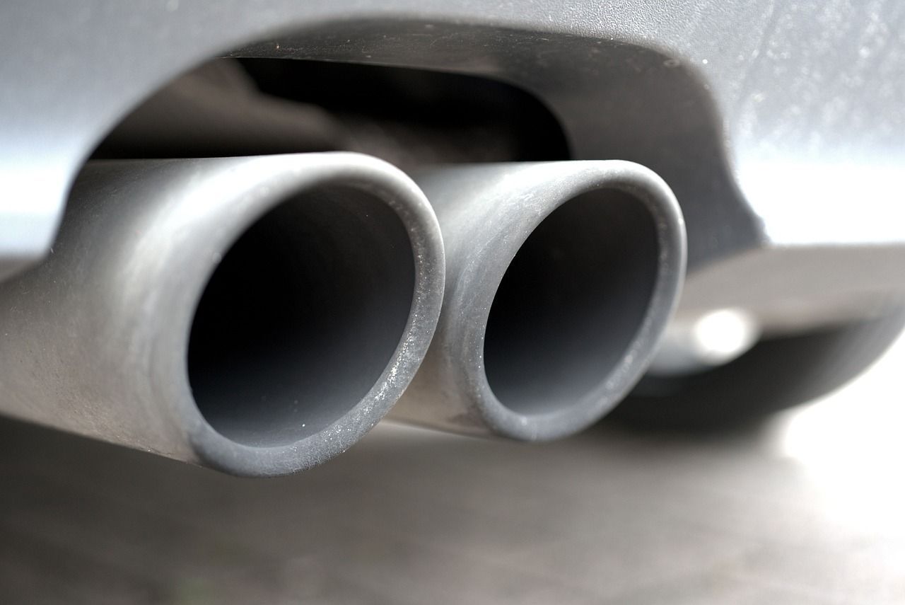 Dual exhaust pipes protruding from the rear of a car.