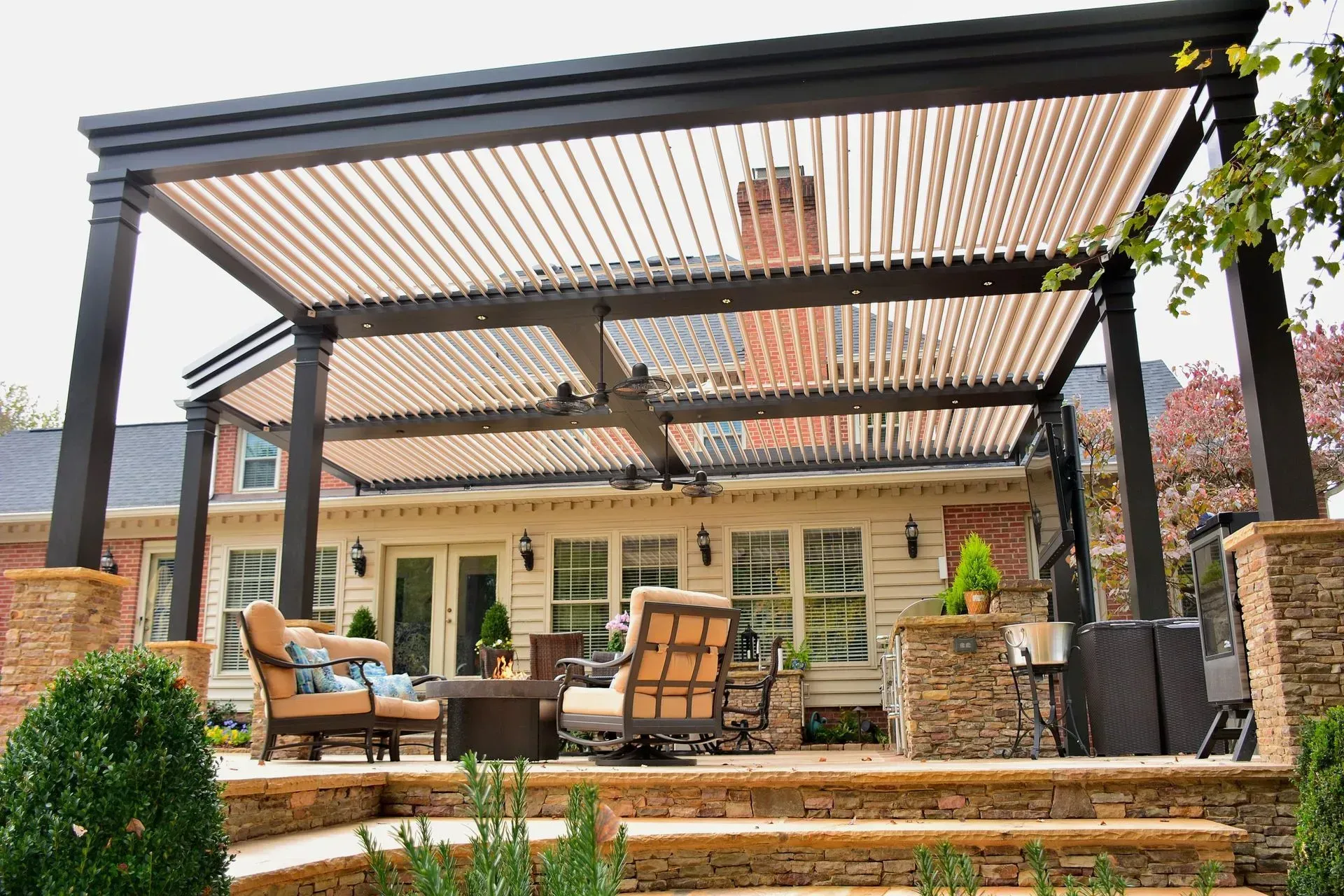 A patio with a pergola and a lot of furniture
