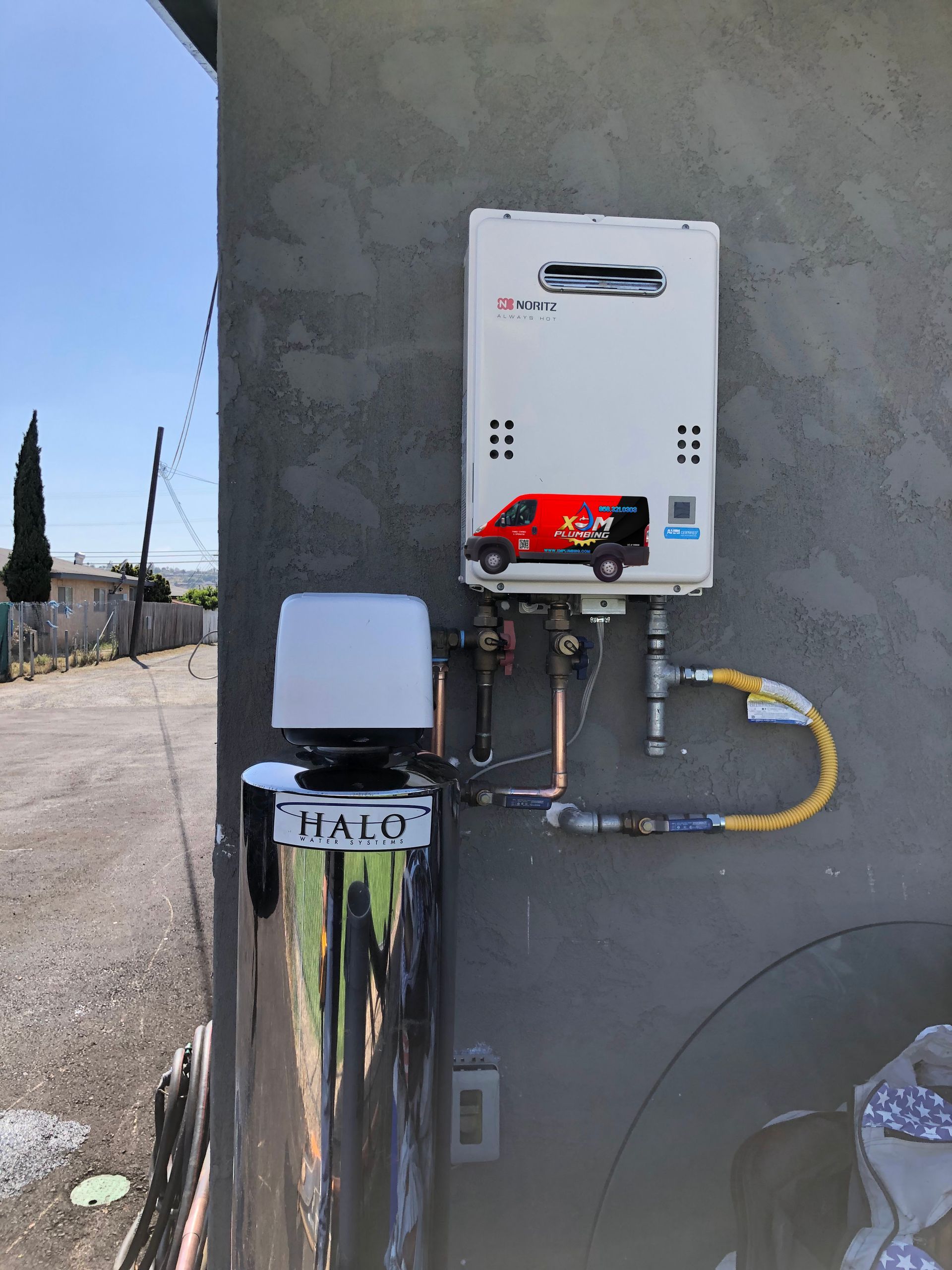A water heater is attached to the side of a building.