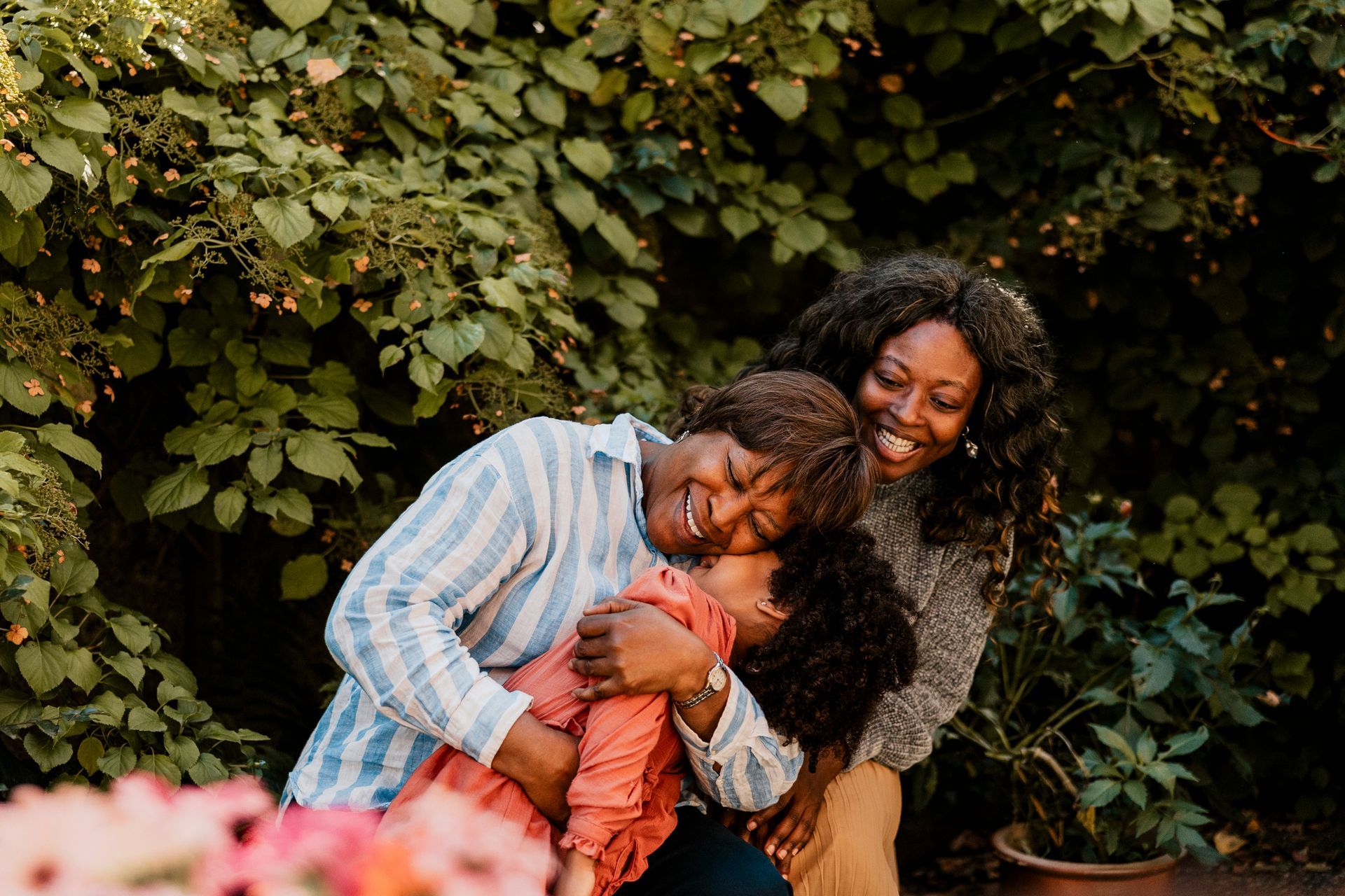 Smiling senior woman embracing granddaughter.