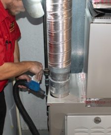 FAMILY HEATING Service Technician performing annual furnace maintenance on the heating system. FAMILY HEATING Service Technician performing annual furnace maintenance on the heating system.