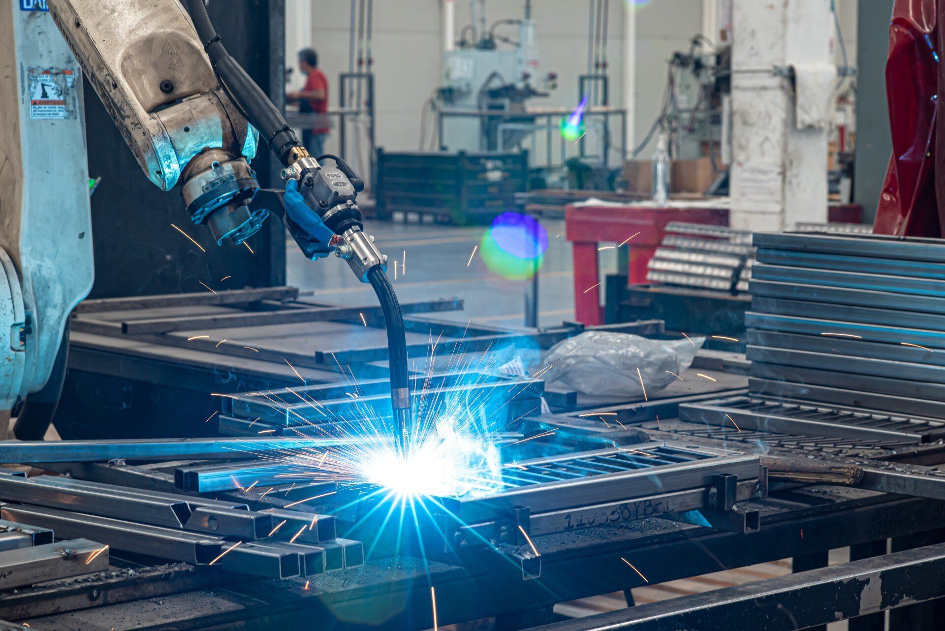 A robot is welding a piece of metal in a factory.