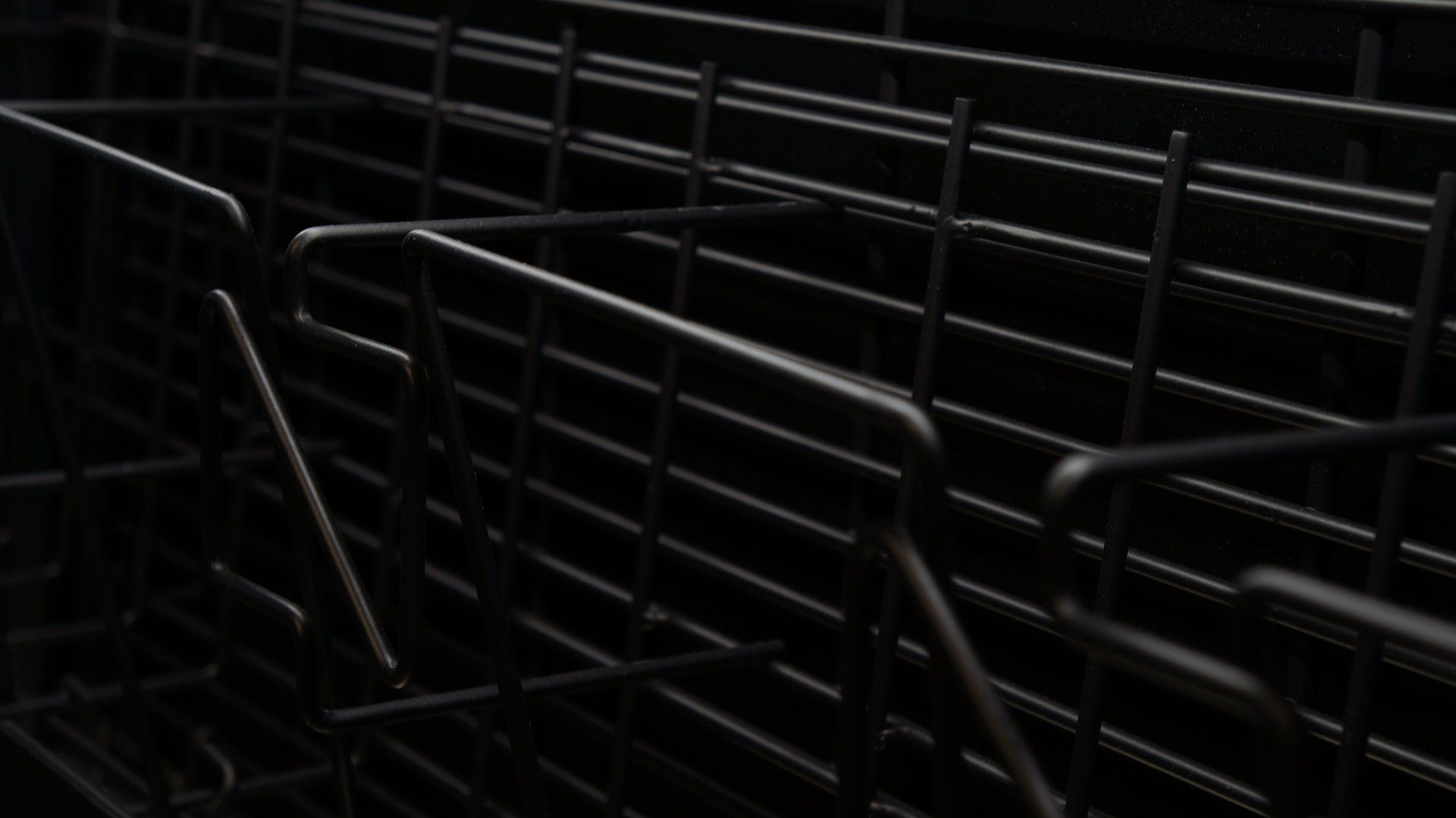 A close up of a black metal fence in the dark.
