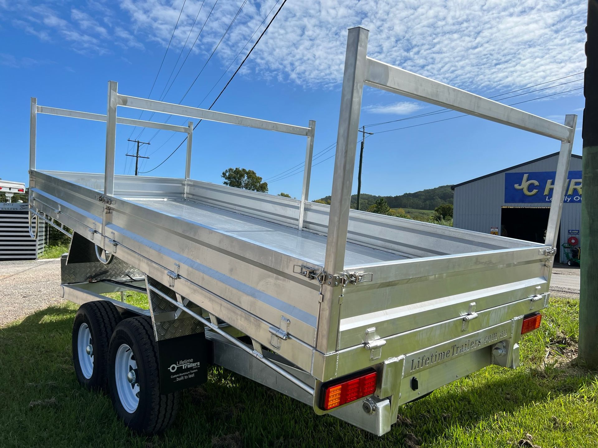 Dark Gray Pickup Truck With Custom Flatbed, Parked on Grass — Rod's Engineering & Lifetime Trailers in Bli Bli, QLD