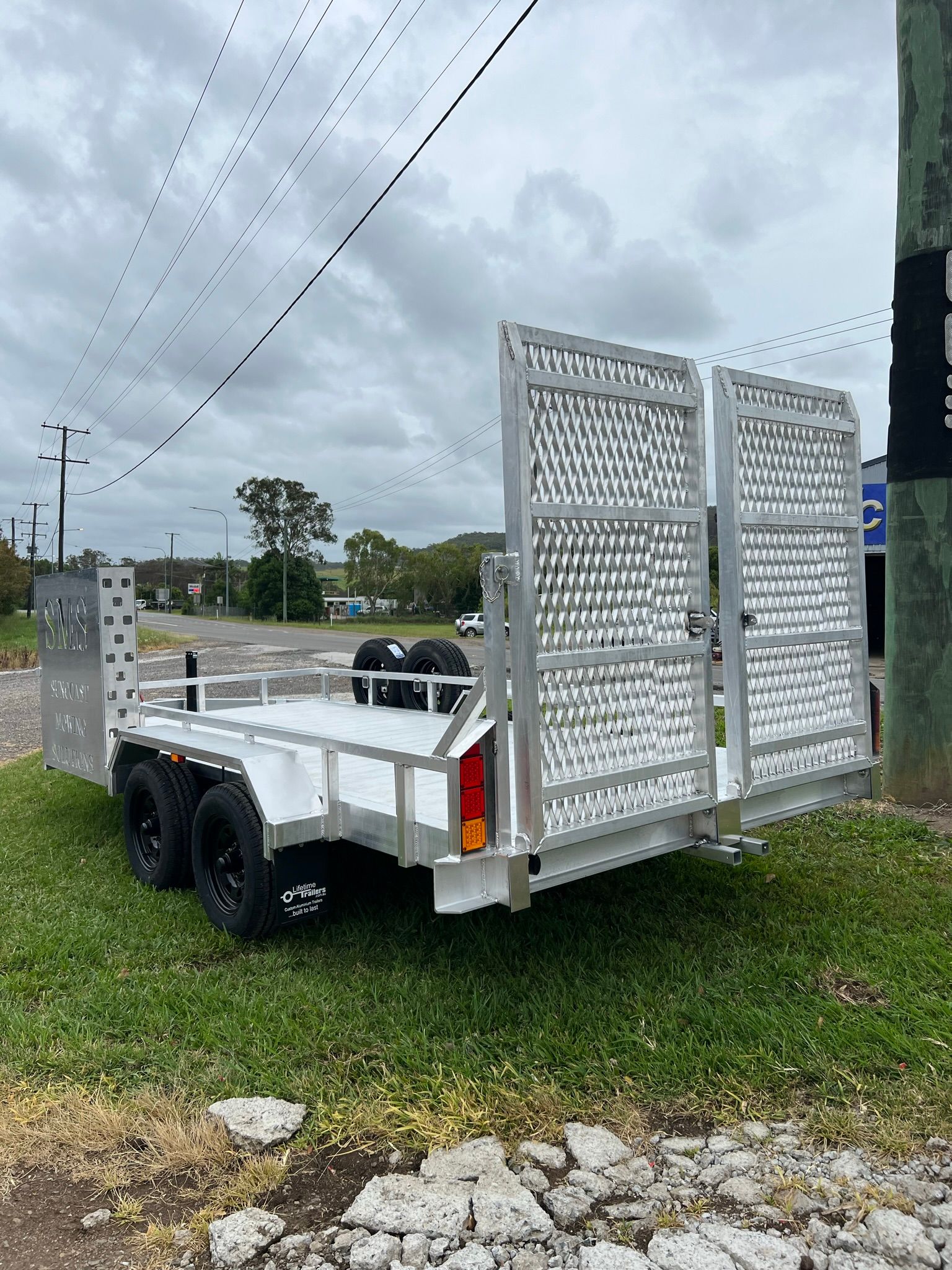 Aluminum Trailer on Grass With Blue Sky — Rod's Engineering & Lifetime Trailers in Bli Bli, QLD