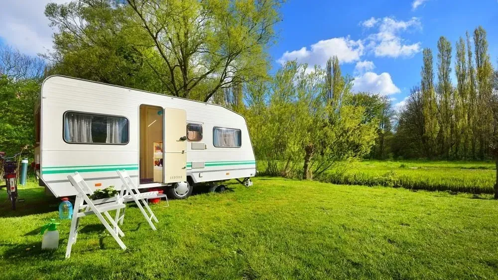 White Camper Trailer Parked on Green Grass — Rod's Engineering & Lifetime Trailers in Bli Bli, QLD
