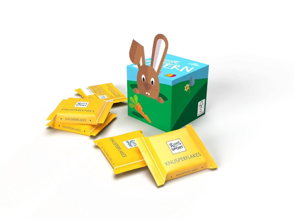 Osterhasen-Geschenkbox, umgeben von gelben Schokoladen