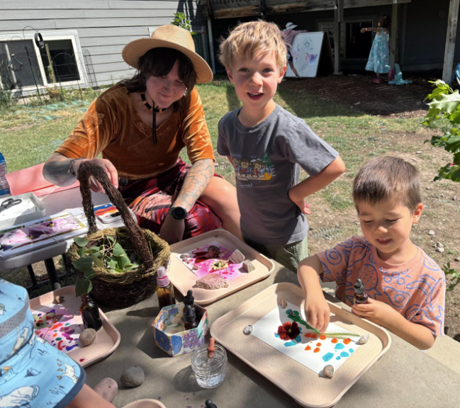Montessori guide and childrens working outdoors