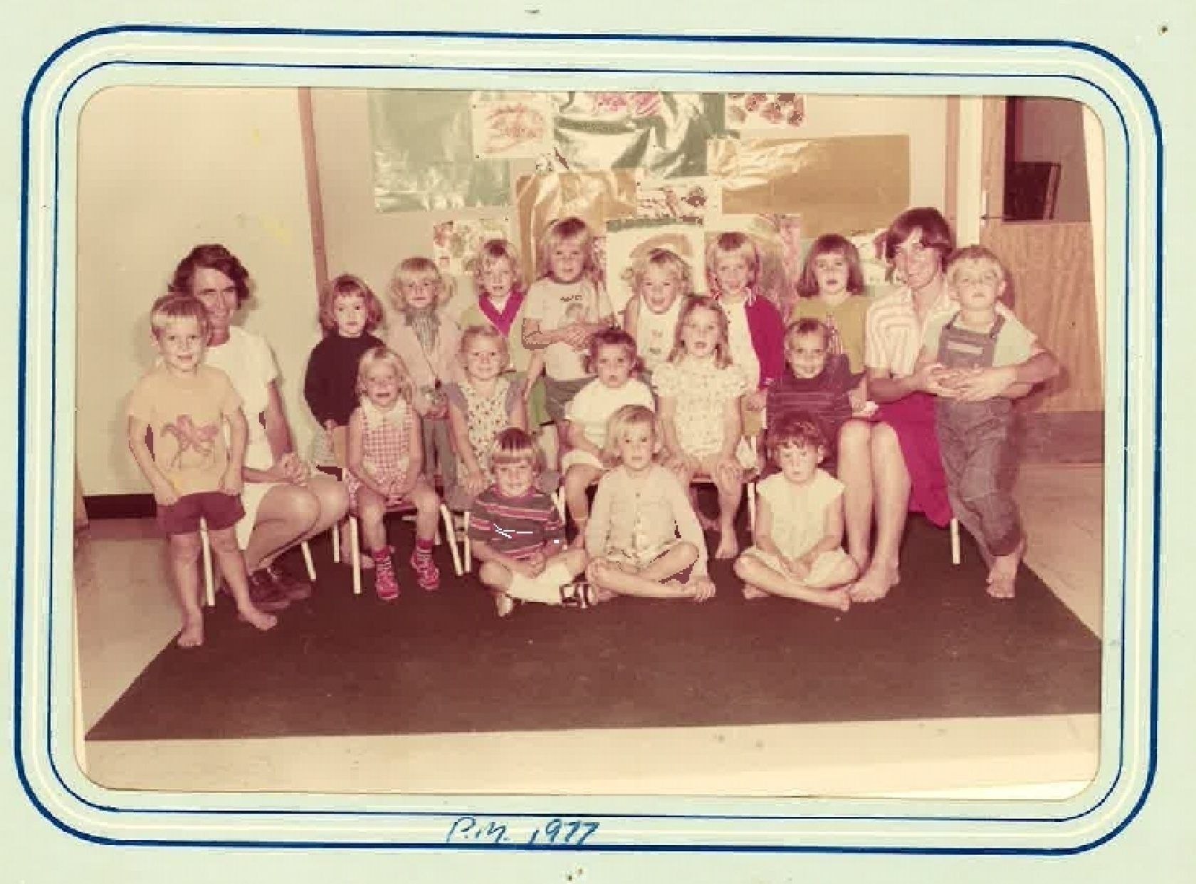 A group of children are posing for a picture in a room