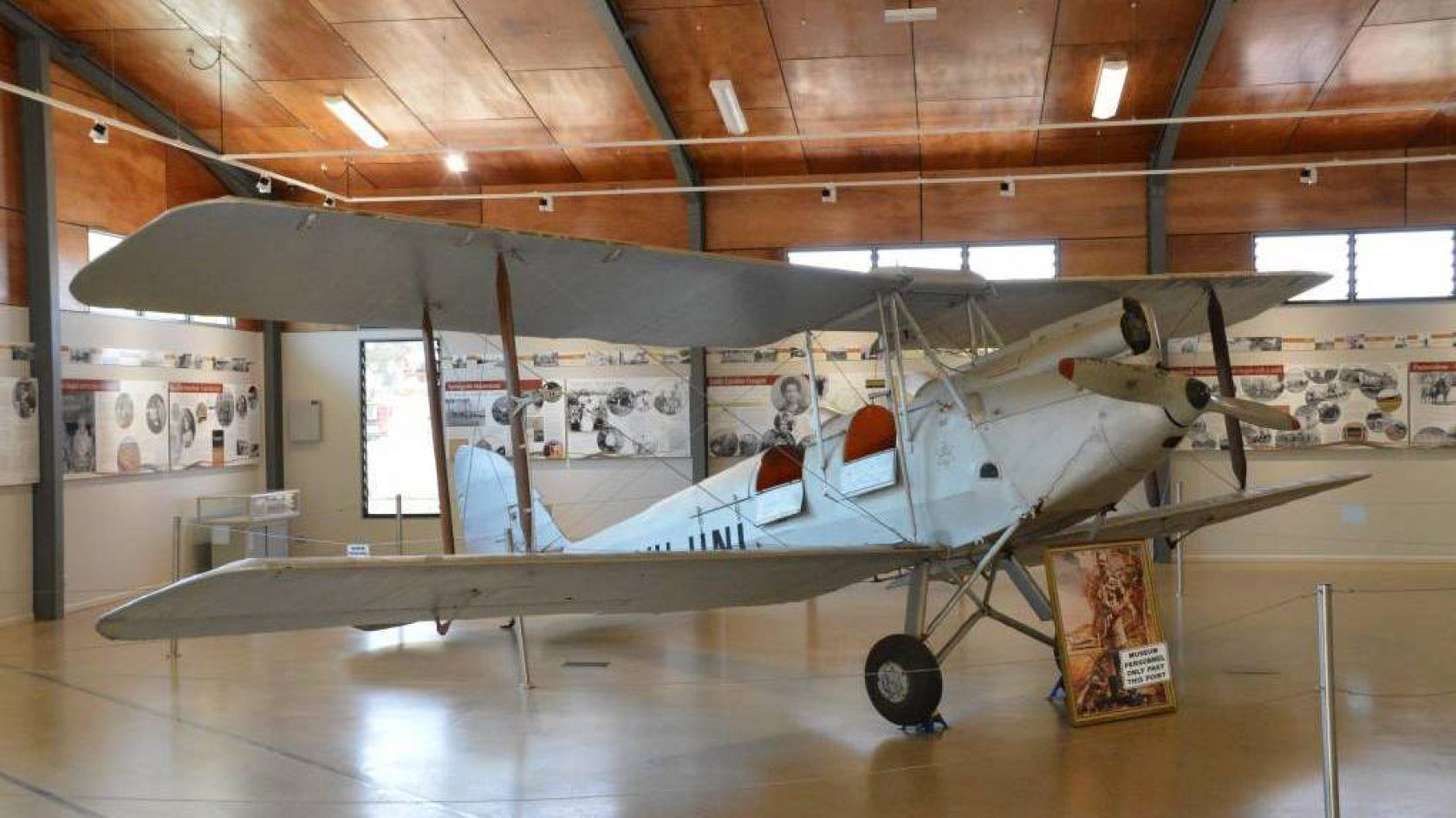 An old airplane is sitting in a museum.