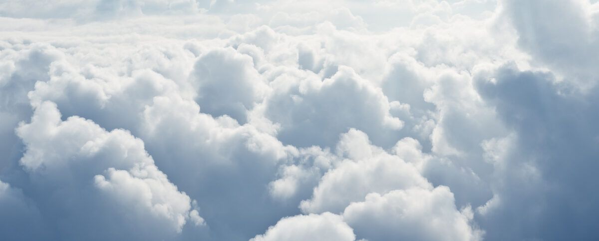 Soft white clouds filling the sky, forming a fluffy cloudscape.