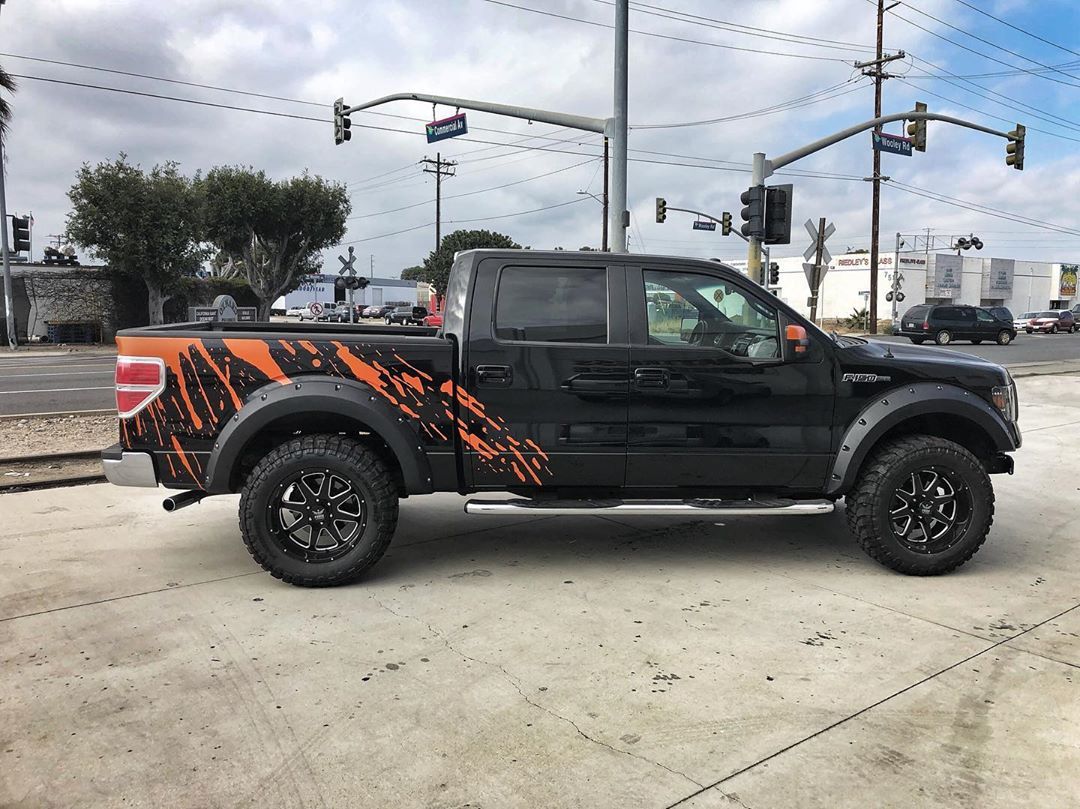 A black pickup truck is parked on the side of the road.