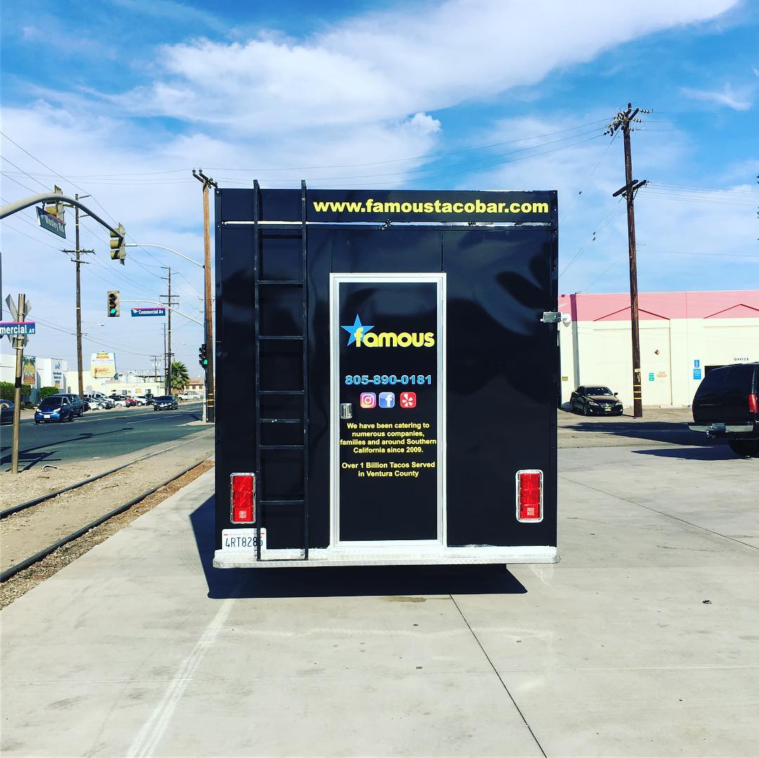 A famous mustache food truck is parked in a parking lot