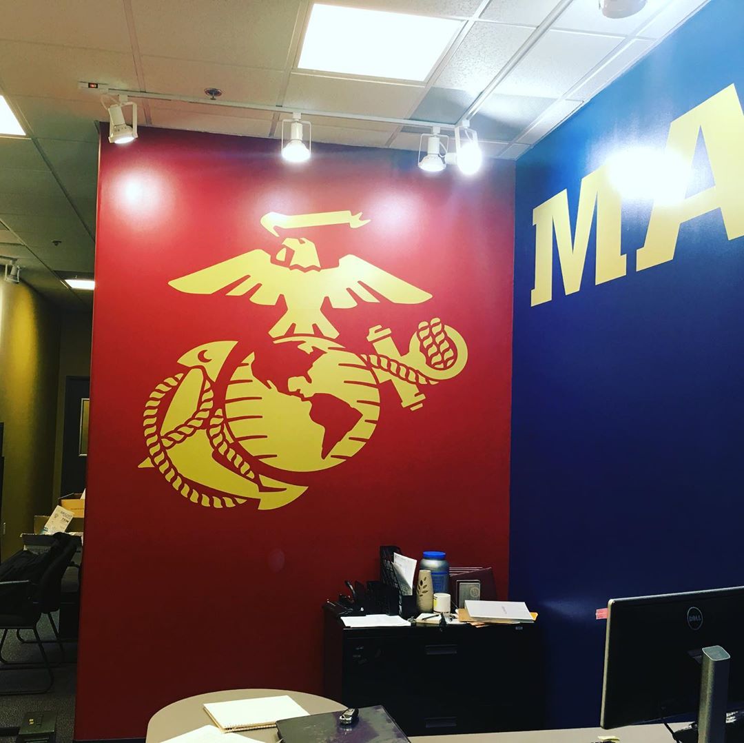 A red wall with a marine corps logo on it