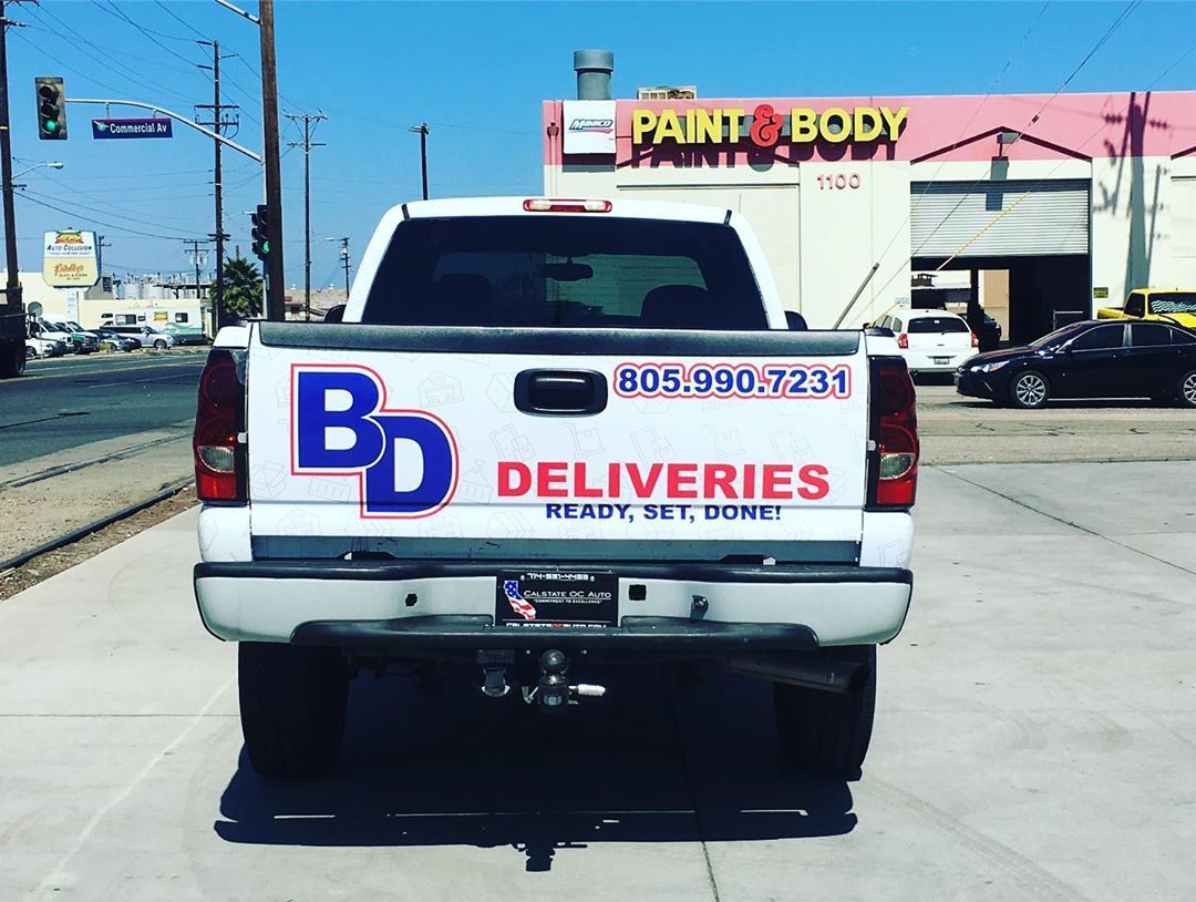 A white truck with bd deliveries written on the back