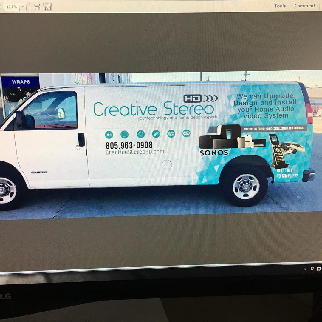 A white van that says creative stereo on the side