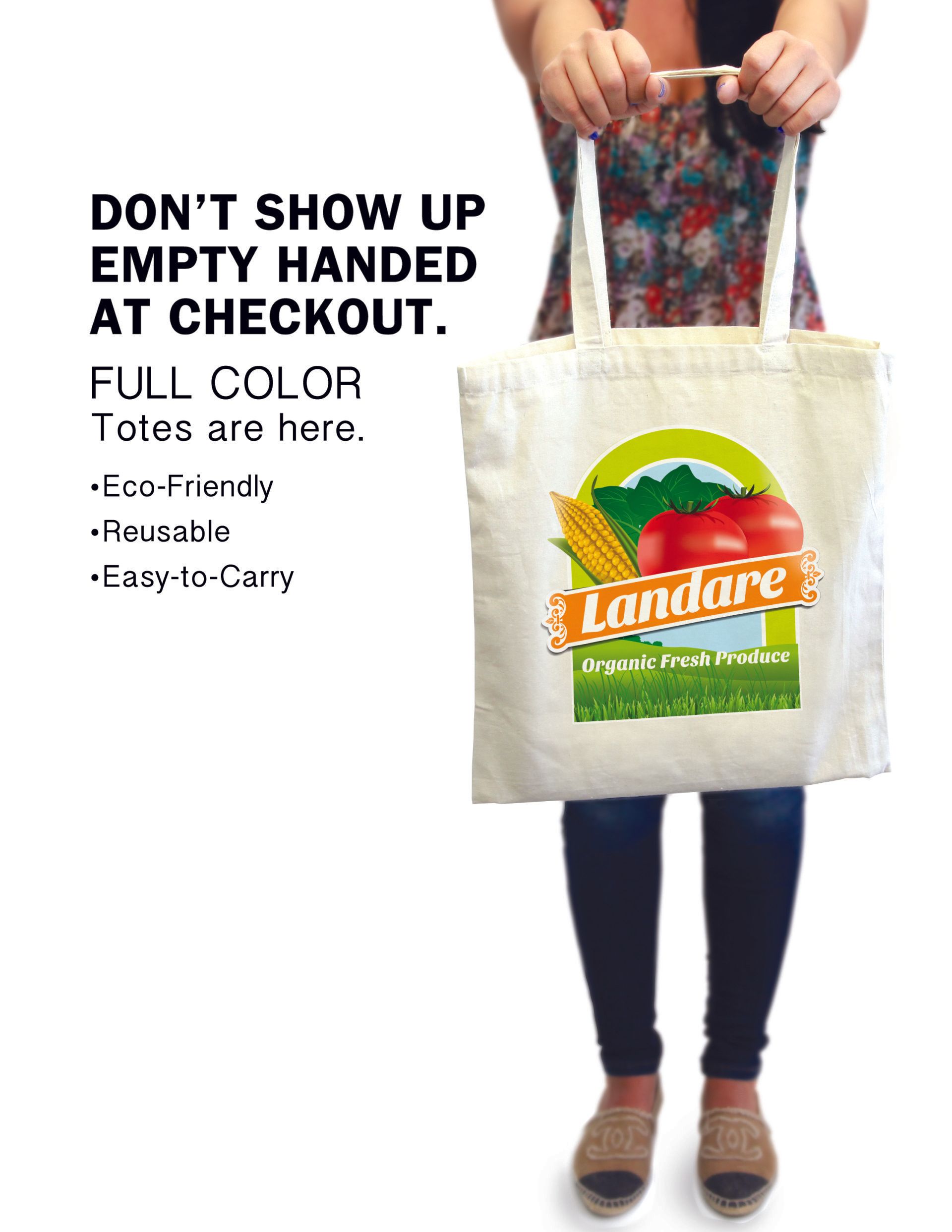 A woman is holding a tote bag that says landare on it.