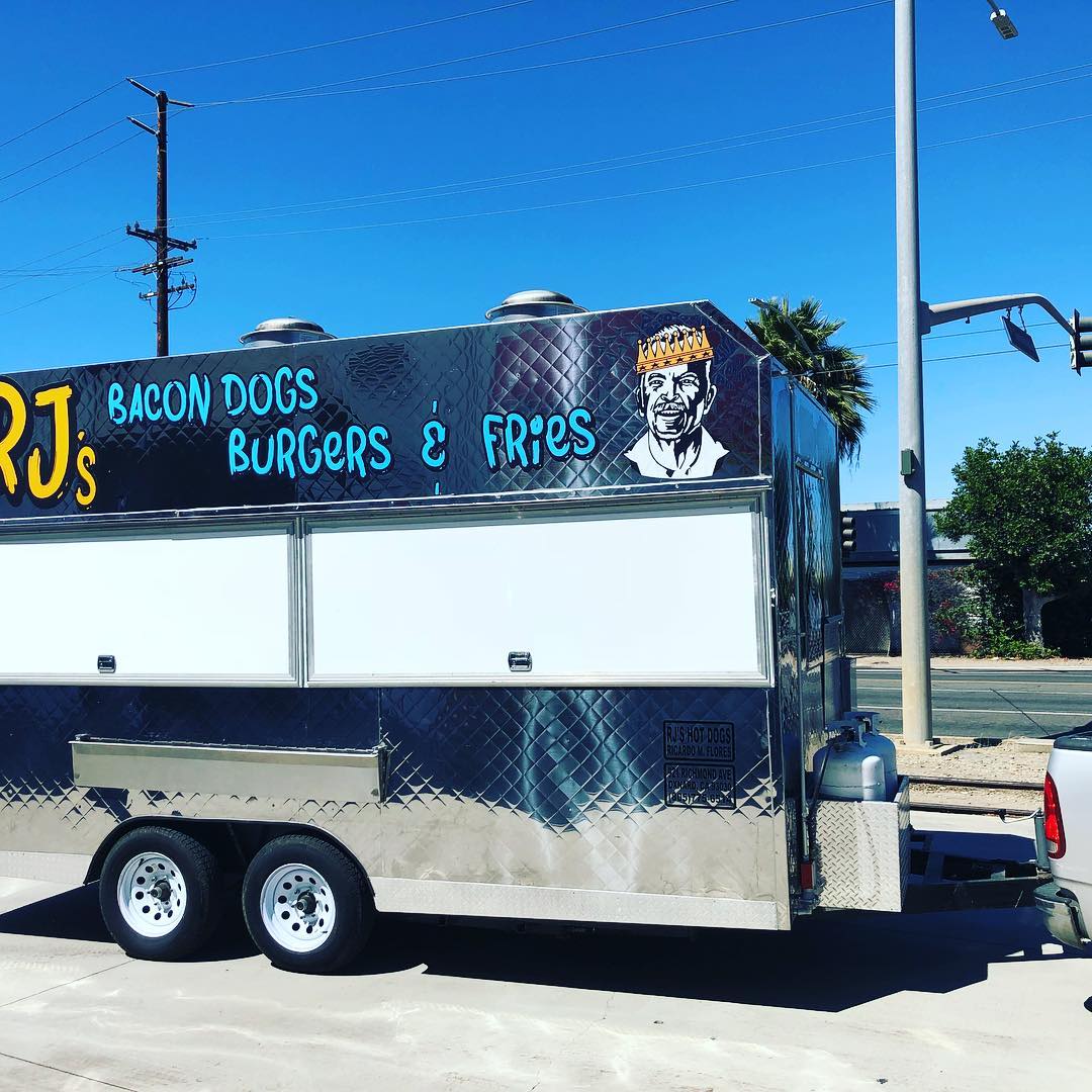 A food truck that sells bacon dogs burgers and fries