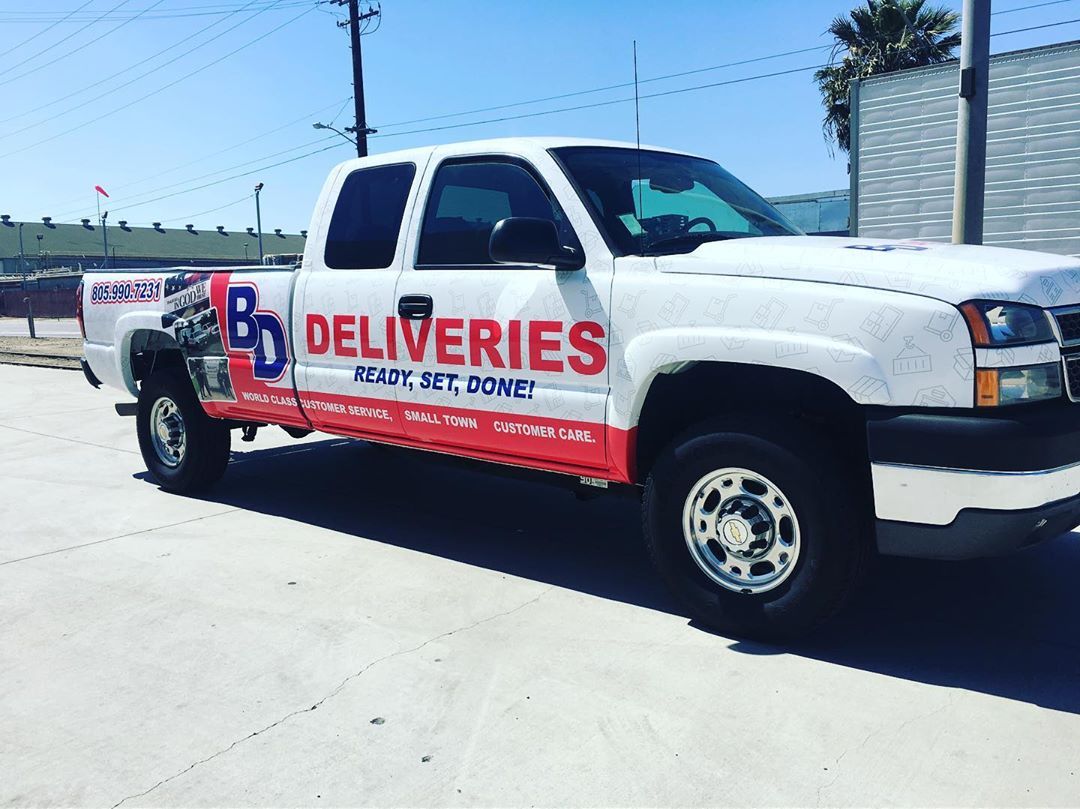 A white truck with the word deliveries on it